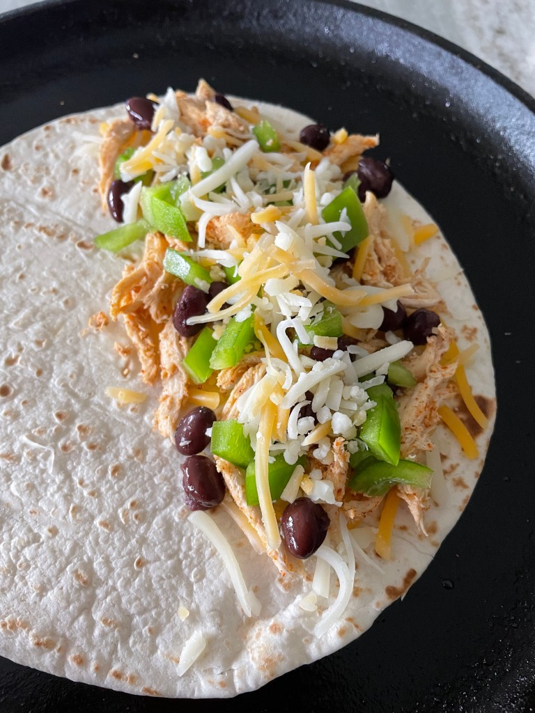 add cheese on top as well so the tortillas sticks together